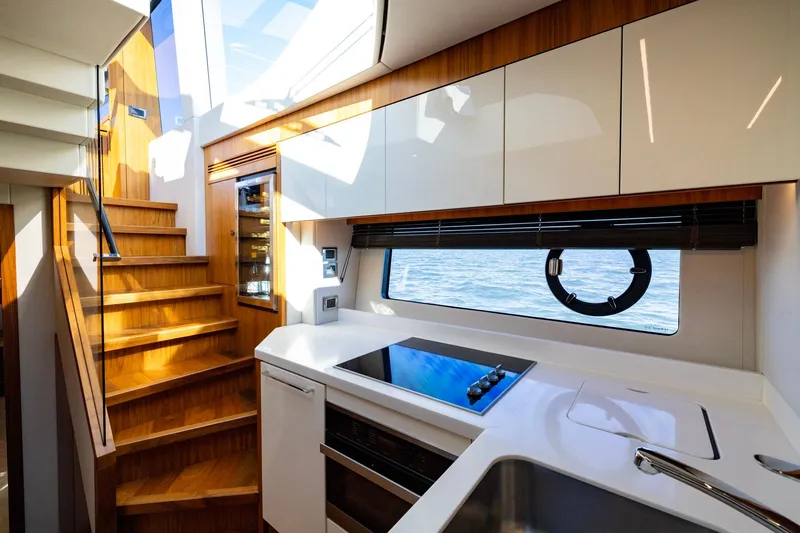 Kb Jr Yacht Photos Pics Luxurious interior of 2020 Sunseeker Predator 74 yacht with modern kitchen and wooden stairs.