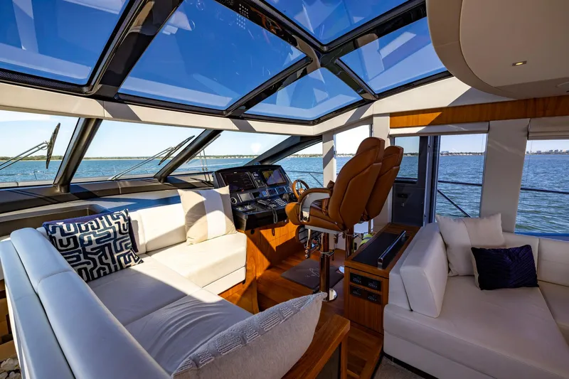 Kb Jr Yacht Photos Pics Luxurious interior of 2020 Sunseeker Predator 74 yacht with panoramic windows and plush seating.