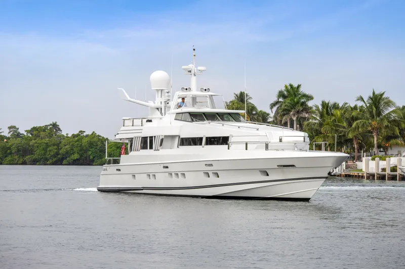  Yacht Photos Pics 1989 Oceanfast Motor Yacht cruising on a calm waterway with palm trees in the background.