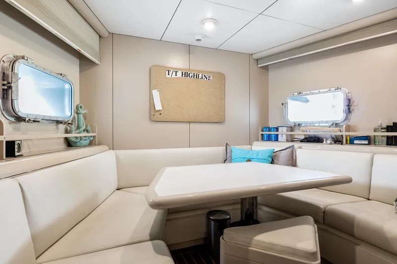  Yacht Photos Pics Luxurious dining area inside a 1989 Oceanfast Motor Yacht with white leather seating.