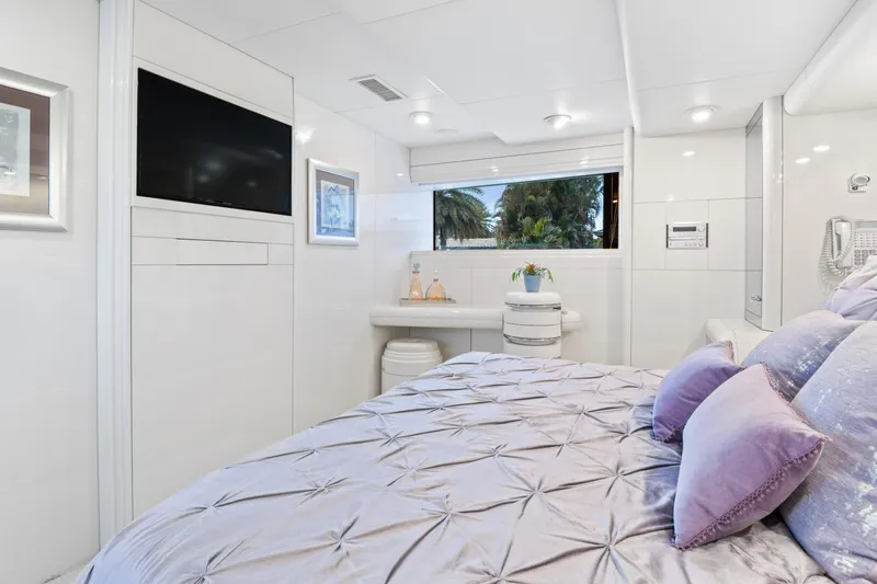  Yacht Photos Pics Luxurious bedroom in a 1989 Oceanfast Motor Yacht with modern decor and large window.