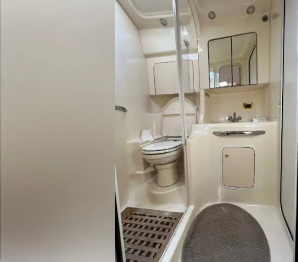 Adagio Yacht Photos Pics 1999 Sea Ray 380 Sundancer bathroom with toilet, sink, and mirror in compact marine design.