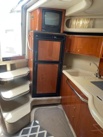 Adagio Yacht Photos Pics Interior of 1999 Sea Ray 380 Sundancer with kitchenette, fridge, and stairs.