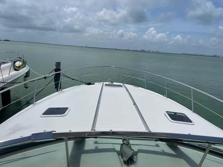 Adagio Yacht Photos Pics 1999 Sea Ray 380 Sundancer yacht on calm water under cloudy sky.