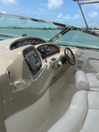 Adagio Yacht Photos Pics 1999 Sea Ray 380 Sundancer helm with leather seats and modern navigation equipment.