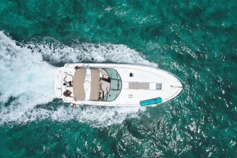 Adagio Yacht Photos Pics Overhead view of 1999 Sea Ray 380 Sundancer cruising on clear turquoise water.