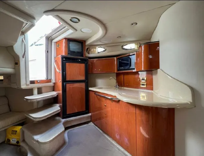 Adagio Yacht Photos Pics Interior of 1999 Sea Ray 380 Sundancer yacht with kitchenette and stairs.