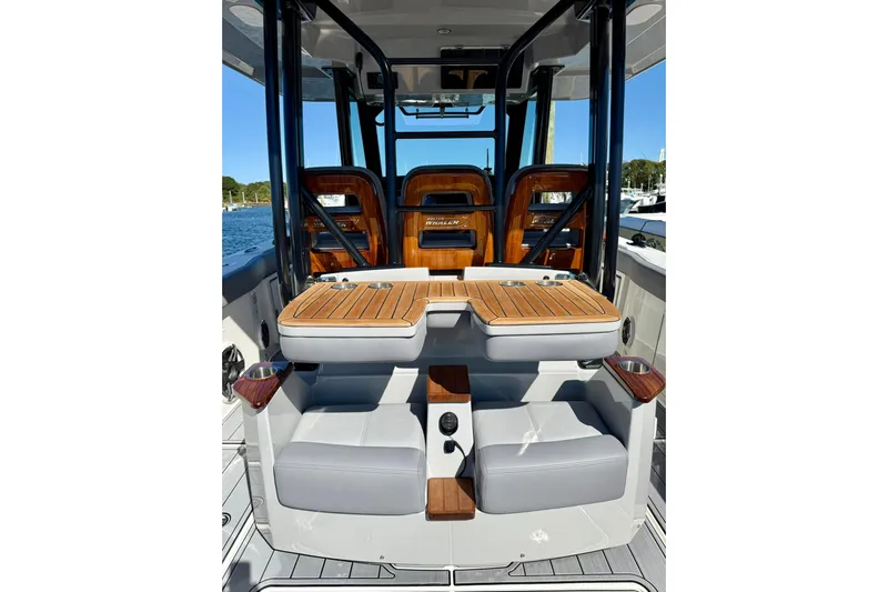 Ghost Rider Yacht Photos Pics 2024 Boston Whaler 360 Outrage interior with luxurious seating and wooden accents.