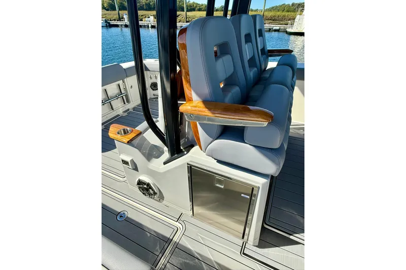 Ghost Rider Yacht Photos Pics 2024 Boston Whaler 360 Outrage interior seating with armrests and storage.