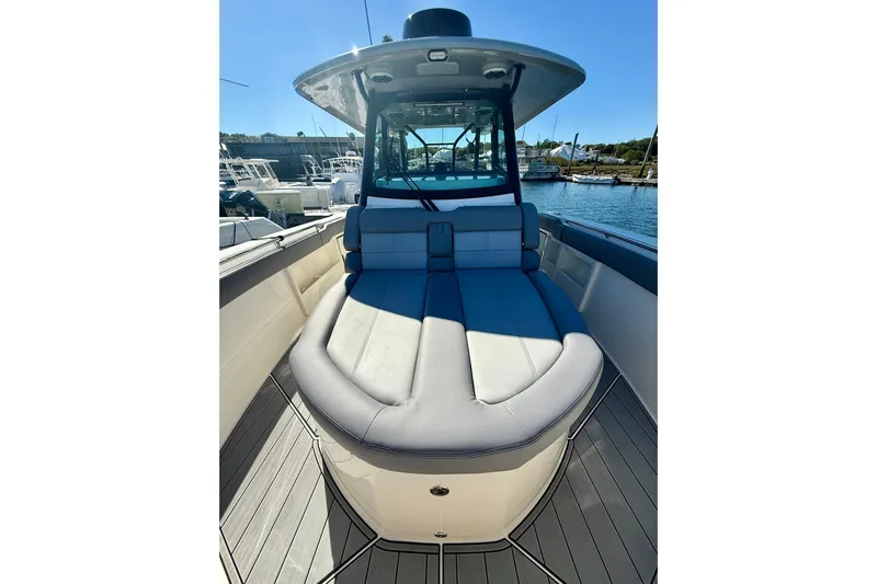 Ghost Rider Yacht Photos Pics 2024 Boston Whaler 360 Outrage boat interior with cushioned seating and sleek design.