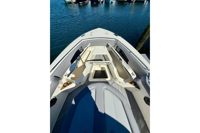 Ghost Rider Yacht Photos Pics 2024 Boston Whaler 360 Outrage boat interior with seating and storage, docked on water.