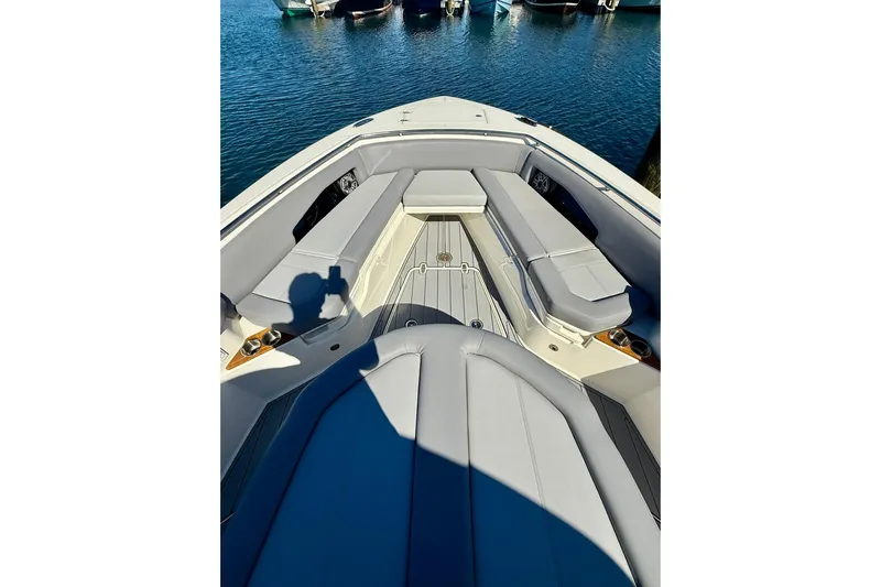 Ghost Rider Yacht Photos Pics 2024 Boston Whaler 360 Outrage boat interior with cushioned seating and sleek design.