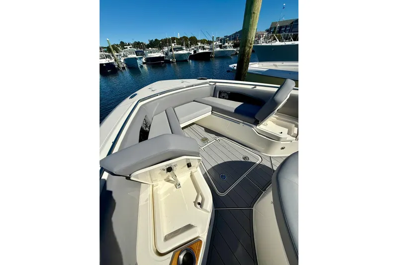 Ghost Rider Yacht Photos Pics 2024 Boston Whaler 360 Outrage boat interior with seating and storage, docked at marina.