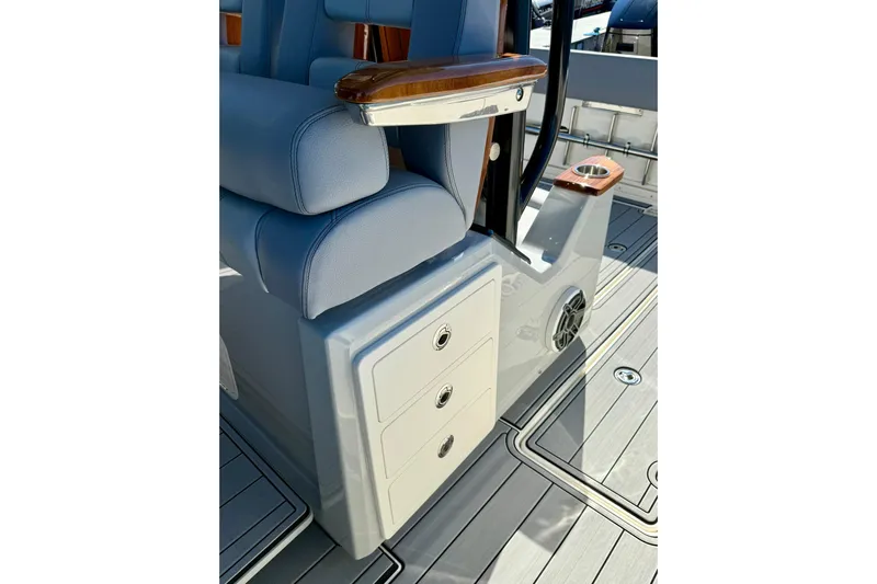 Ghost Rider Yacht Photos Pics 2024 Boston Whaler 360 Outrage interior with seating, storage, and cup holders.