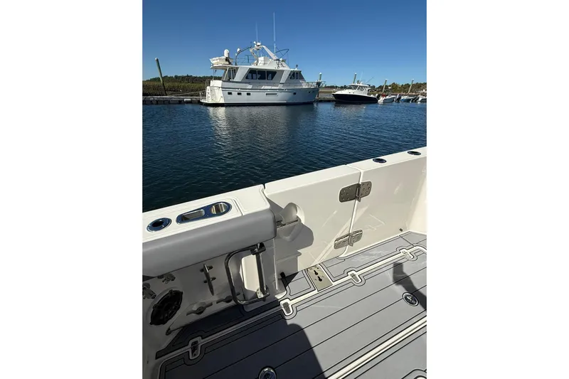 Ghost Rider Yacht Photos Pics 2024 Boston Whaler 360 Outrage boat interior with marina view in background.