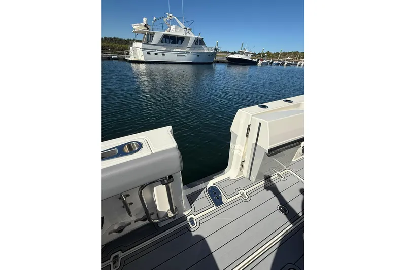 Ghost Rider Yacht Photos Pics 2024 Boston Whaler 360 Outrage boat deck with marina view in the background.