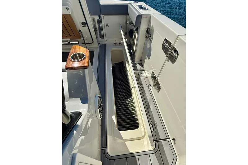 Ghost Rider Yacht Photos Pics 2024 Boston Whaler 360 Outrage boat deck with storage compartment and cup holder.