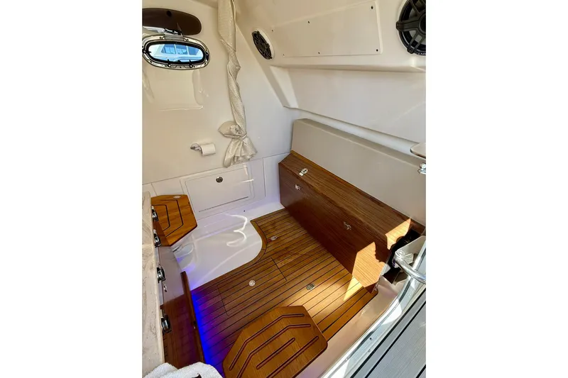 Ghost Rider Yacht Photos Pics 2024 Boston Whaler 360 Outrage cabin interior with wood flooring and modern design.