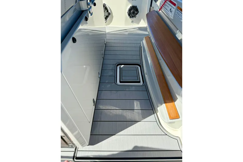 Ghost Rider Yacht Photos Pics 2024 Boston Whaler 360 Outrage interior with sleek flooring and wood accents.