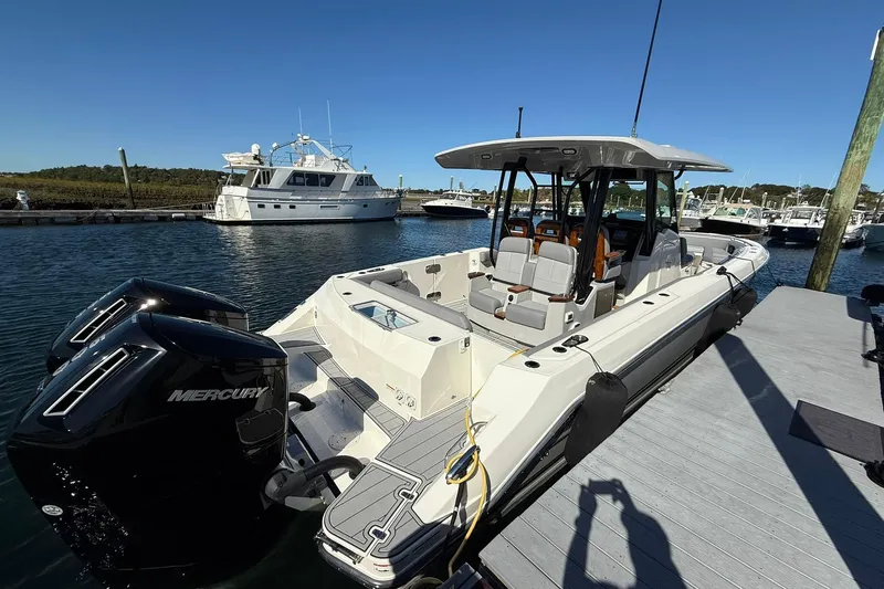 Ghost Rider Yacht Photos Pics 2024 Boston Whaler 360 Outrage docked, featuring dual Mercury engines, in a marina setting.
