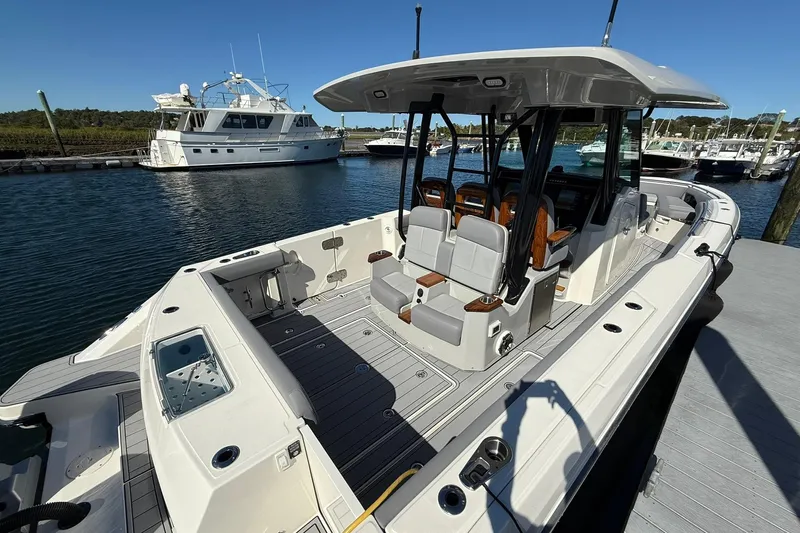 Ghost Rider Yacht Photos Pics 2024 Boston Whaler 360 Outrage boat docked, showcasing spacious deck and seating.