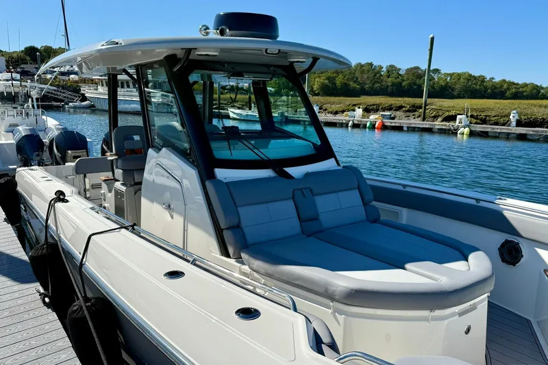 Ghost Rider Yacht Photos Pics 2024 Boston Whaler 360 Outrage boat docked, featuring sleek design and spacious seating.