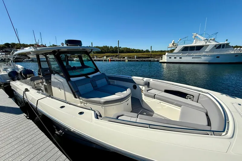 Ghost Rider Yacht Photos Pics 2024 Boston Whaler 360 Outrage boat docked in a marina under clear blue skies.