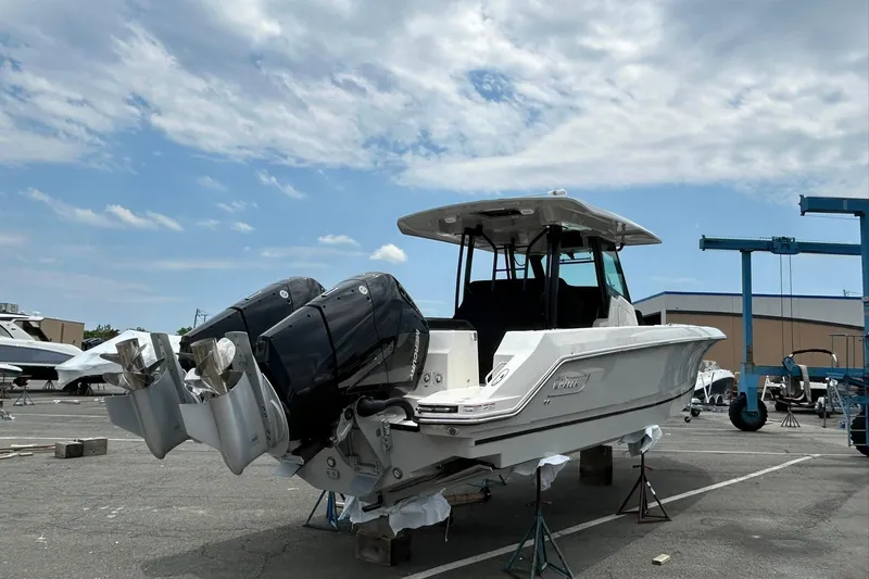 Ghost Rider Yacht Photos Pics 2024 Boston Whaler 360 Outrage boat with dual outboard engines in a marina setting.