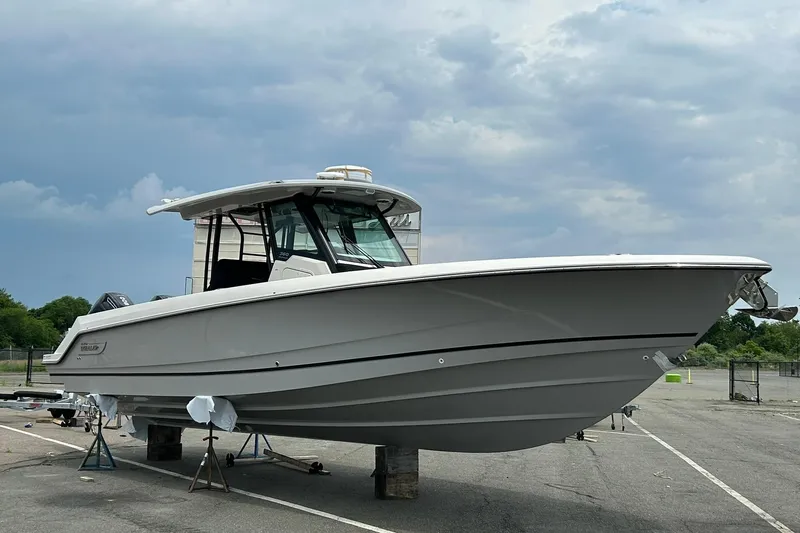 Ghost Rider Yacht Photos Pics 2024 Boston Whaler 360 Outrage boat on display under cloudy sky.