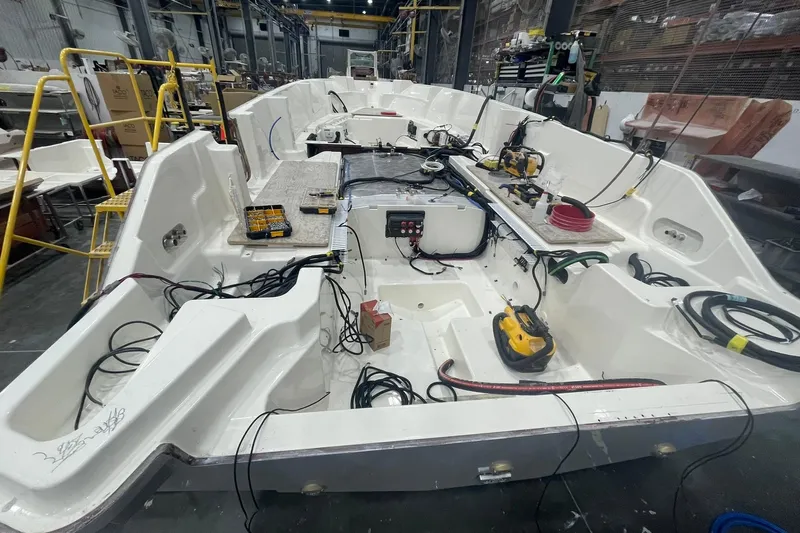 Ghost Rider Yacht Photos Pics 2024 Boston Whaler 360 Outrage under construction in a workshop, showcasing interior wiring and components.