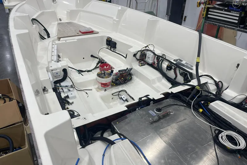 Ghost Rider Yacht Photos Pics 2024 Boston Whaler 360 Outrage boat interior under construction, showcasing wiring and components.