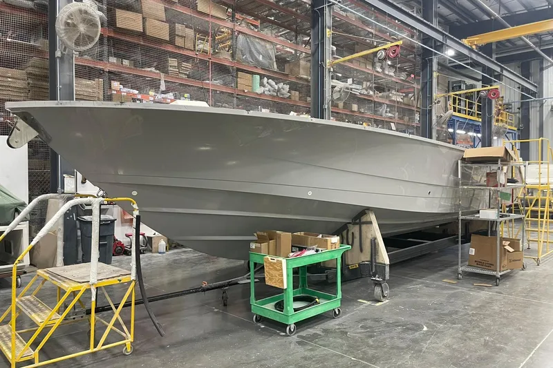 Ghost Rider Yacht Photos Pics 2024 Boston Whaler 360 Outrage boat under construction in a factory setting.