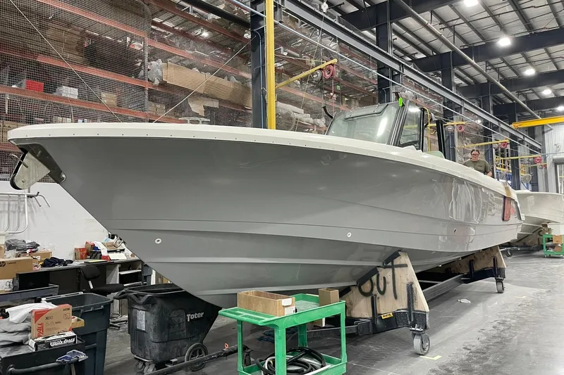 Ghost Rider Yacht Photos Pics 2024 Boston Whaler 360 Outrage boat in a manufacturing facility.
