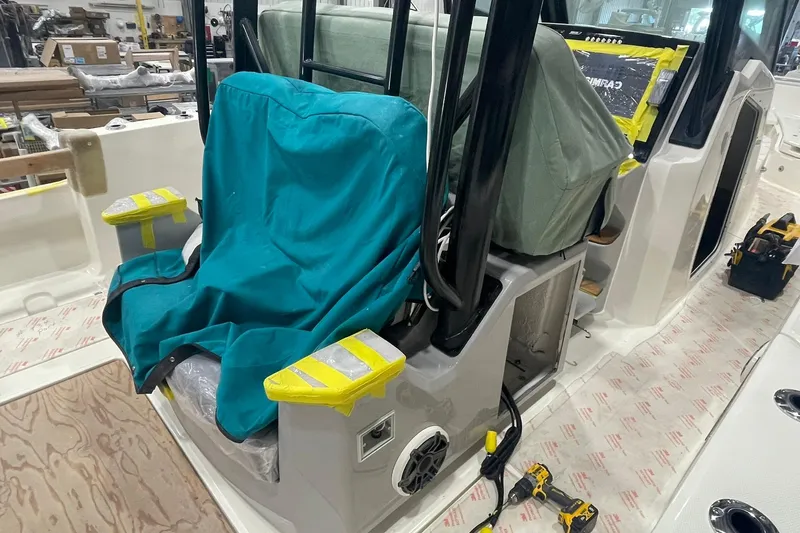 Ghost Rider Yacht Photos Pics 2024 Boston Whaler 360 Outrage interior under construction, featuring covered seating and tools.