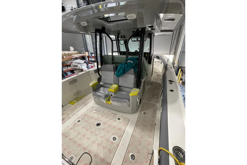 Ghost Rider Yacht Photos Pics 2024 Boston Whaler 360 Outrage boat interior with seating and storage areas.