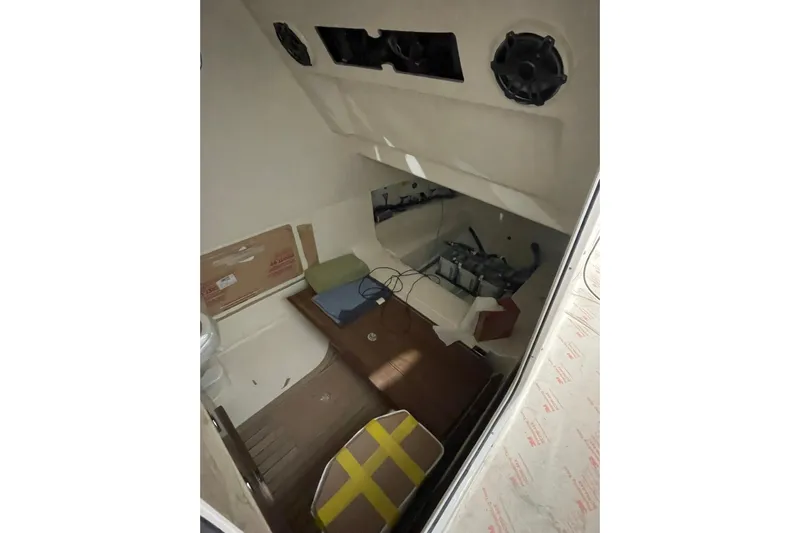 Ghost Rider Yacht Photos Pics 2024 Boston Whaler 360 Outrage cabin interior with wooden flooring and storage space.