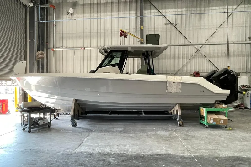 Ghost Rider Yacht Photos Pics 2024 Boston Whaler 360 Outrage boat in a warehouse setting.
