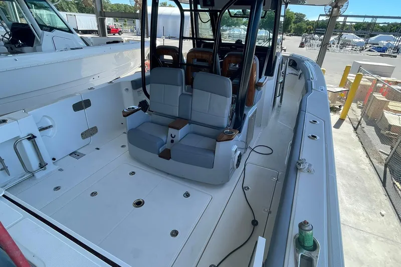Ghost Rider Yacht Photos Pics 2024 Boston Whaler 360 Outrage boat interior with seating and deck view.