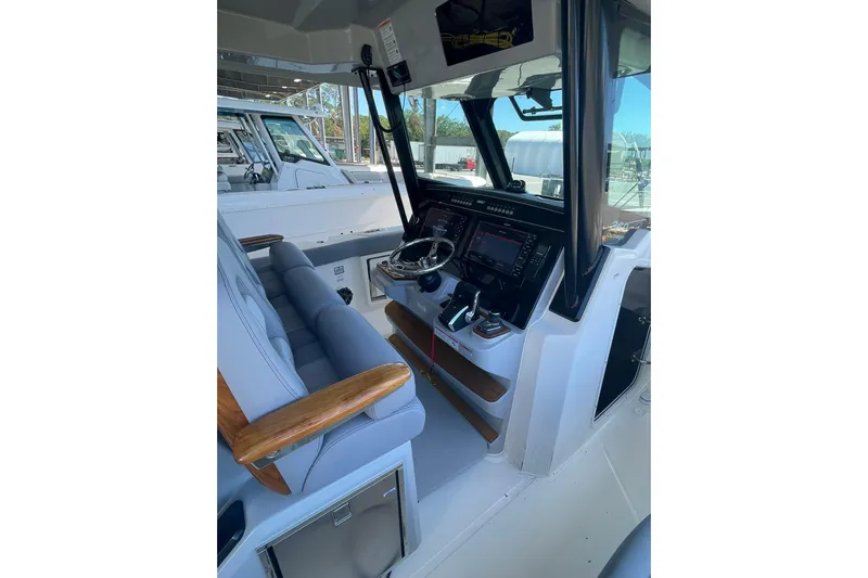 Ghost Rider Yacht Photos Pics 2024 Boston Whaler 360 Outrage helm with advanced navigation systems and comfortable seating.