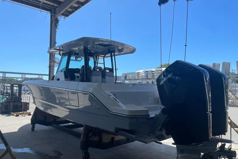 Ghost Rider Yacht Photos Pics 2024 Boston Whaler 360 Outrage boat with dual Mercury engines in a marina setting.