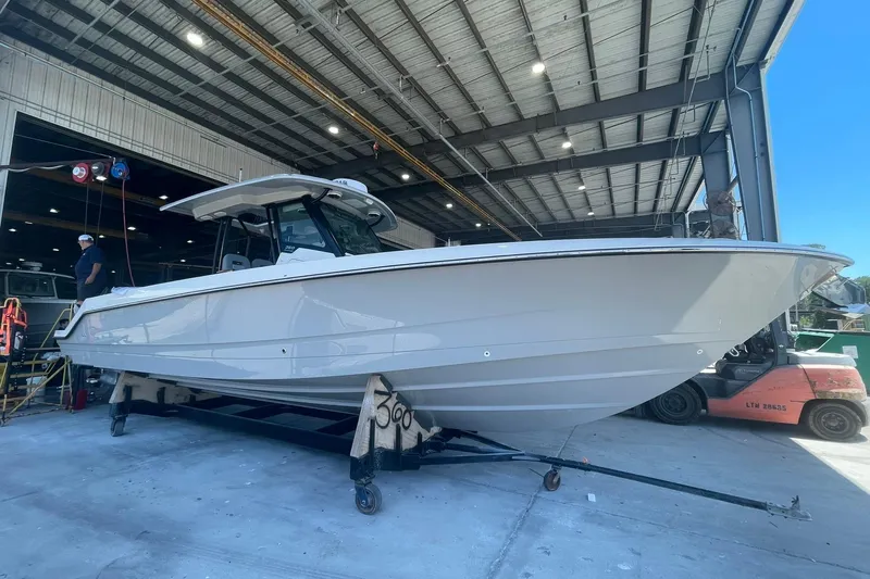 Ghost Rider Yacht Photos Pics 2024 Boston Whaler 360 Outrage boat in a warehouse setting.