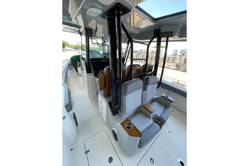 Ghost Rider Yacht Photos Pics 2024 Boston Whaler 360 Outrage interior with seating and helm, showcasing modern design.