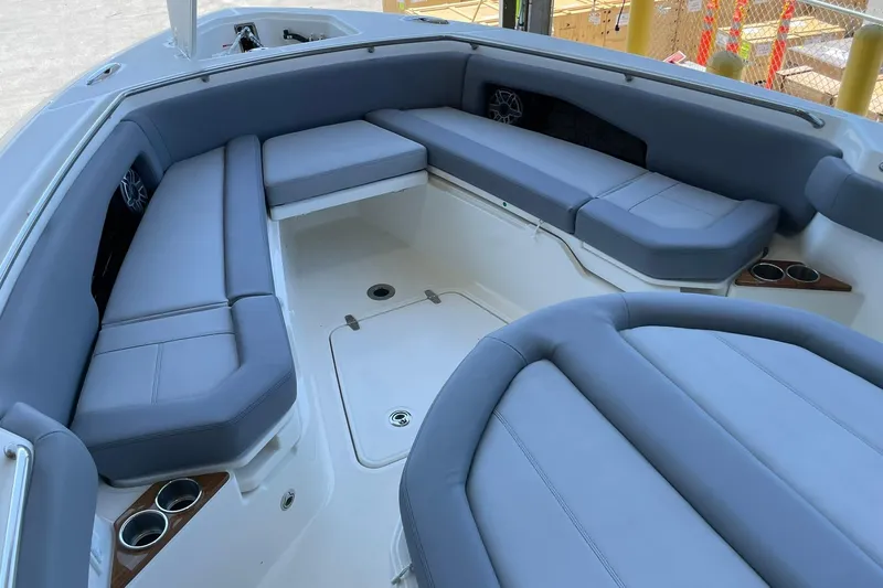 Ghost Rider Yacht Photos Pics 2024 Boston Whaler 360 Outrage boat interior with gray cushioned seating and cup holders.