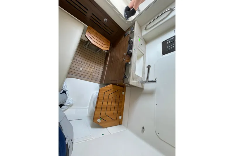 Ghost Rider Yacht Photos Pics 2024 Boston Whaler 360 Outrage interior with wooden accents and modern amenities.