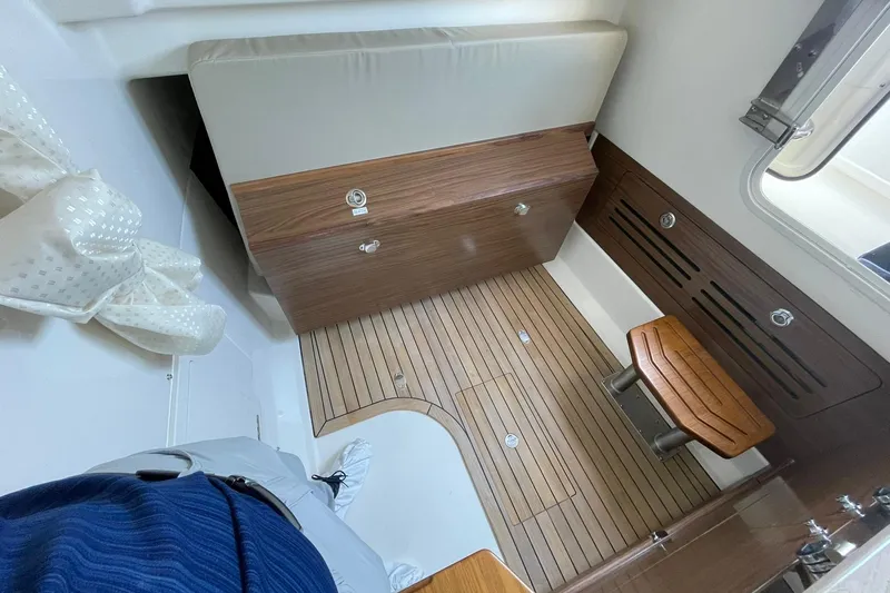 Ghost Rider Yacht Photos Pics 2024 Boston Whaler 360 Outrage cabin interior with wood flooring and seating.