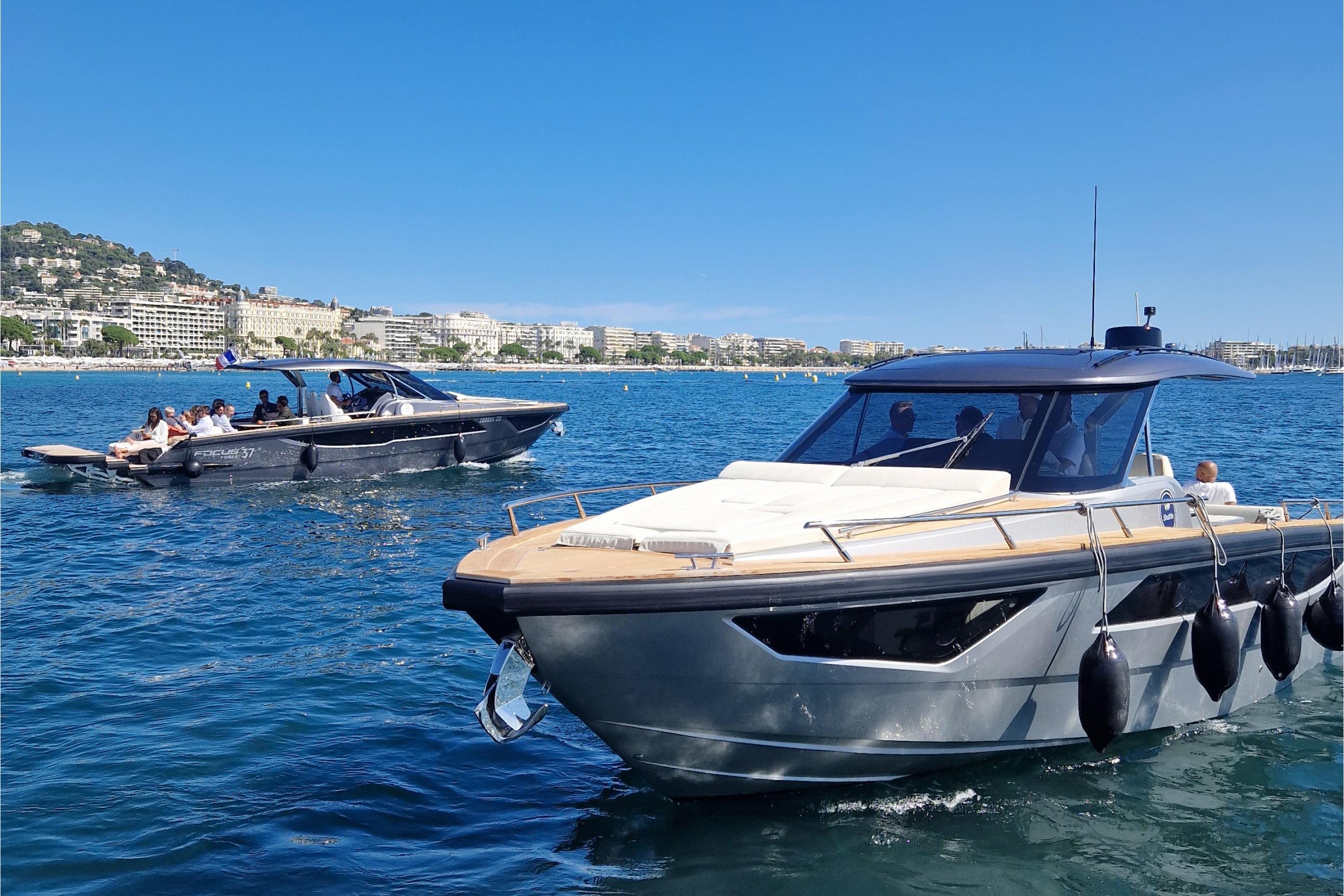 2024 Focus Forza 37 boats cruising on a sunny day in a coastal city.