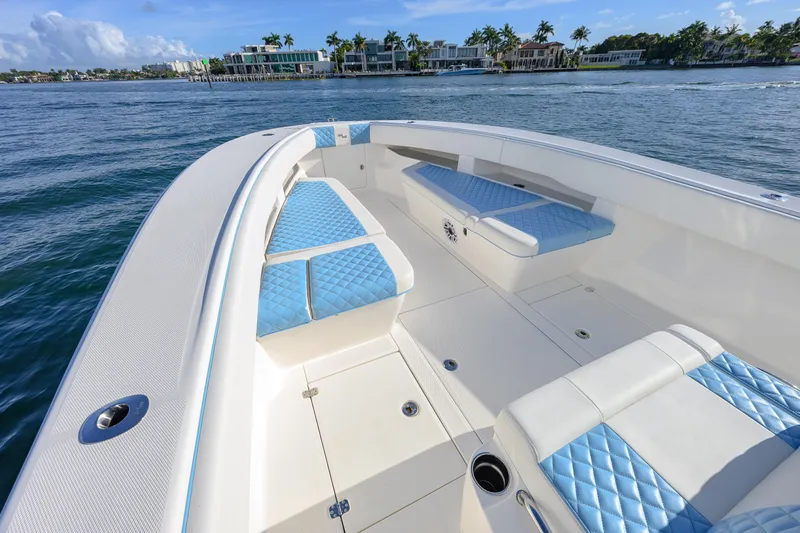  Yacht Photos Pics 2022 SeaVee 340Z boat with blue seating, cruising near waterfront homes.