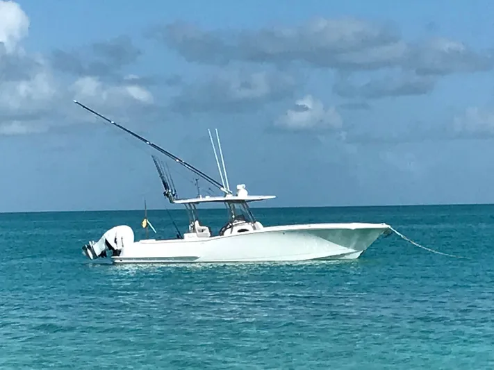  Yacht Photos Pics 2025 Mag Bay 33 boat anchored in clear blue ocean.
