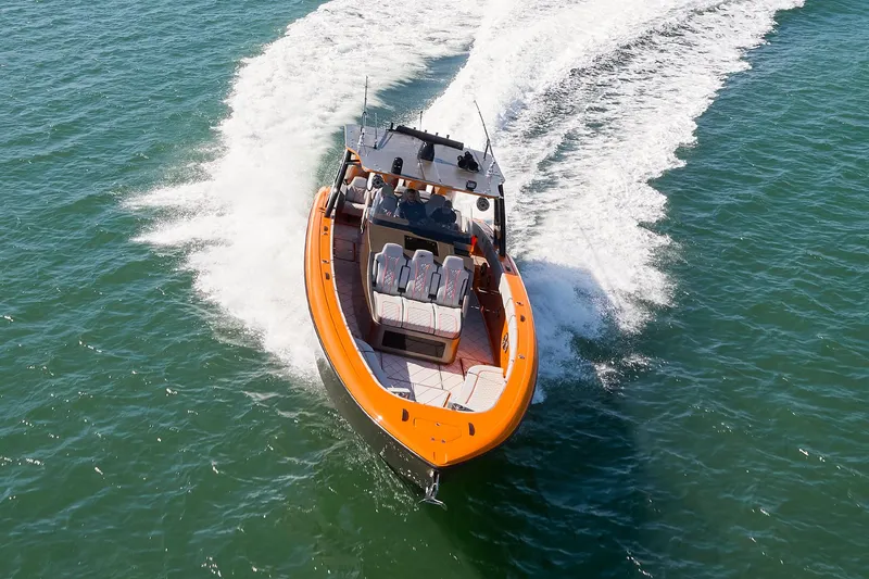 Va Va Vroom Yacht Photos Pics 2020 Midnight Express 43' Open boat cruising on water, featuring vibrant orange accents.