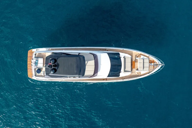  Yacht Photos Pics Aerial view of 2023 Ferretti Yachts 720 on clear blue water.